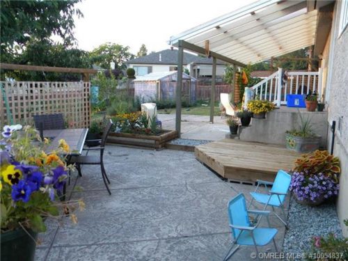 Large back yard with beautiful patio, green house, shed and garden areas in a quiet East Hill location listed by John Deak of Royal LaPage