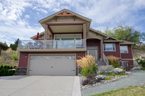 Amazing 4 bed 3 bath home for sale in Coldstream has dream garage and Kal Lake view. Listed by John Deak of Royal LaPage