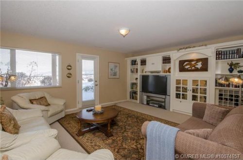 Large basement rec room walks out into the flat backyard at 1236 Mt. Fosthall Drive in Vernon BC listed for sale by John Deak of Royal LaPage.