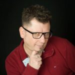 John Deak, in a silly pose because being Your Favourite Realtor® means being professional AND a whole lot of fun.